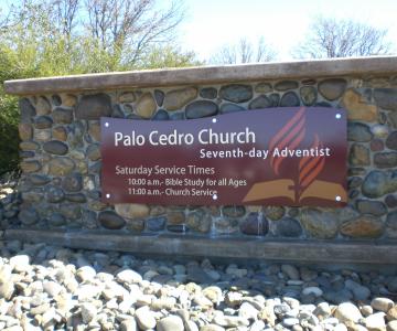 Metal panel with combination of paint and vinyl films.  Standoffs were used to attach to rock monument