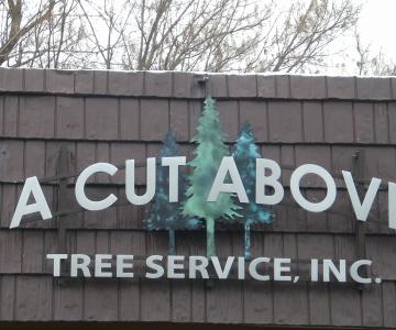 Bronze trees were finished with green patinas and other text is flat cut out aluminum Gemini Brand lettering.  Raceway was used to attach to building.