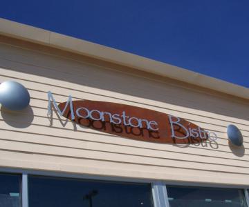 Flat cut out aluminum Gemini Brand letters on distressed steel background with standoffs